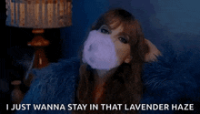 a woman is smoking an electronic cigarette and says `` i just wanna stay in that lavender haze ''