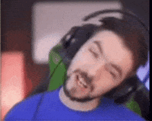 a man with a beard wearing headphones and a microphone