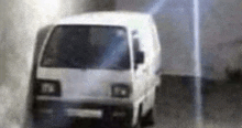 a white van is driving through a tunnel with smoke coming out of the window .