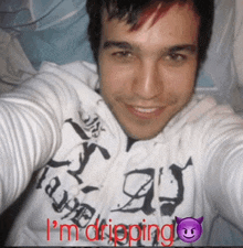 a man wearing a hoodie that says i 'm dripping on it
