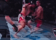two men are fighting in a boxing ring and the clock reads 4:12