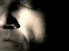 a close up of a woman 's face with her mouth open