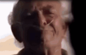 a close up of an elderly woman 's face with a shadow on her face .