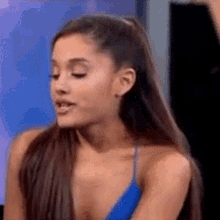 ariana grande is wearing a blue tank top while talking on a television show .