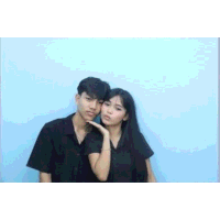 a boy and a girl are posing for a picture together .
