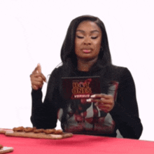a woman is holding a card that says hot ones on it