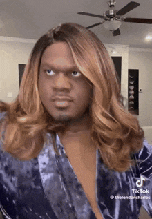 a man wearing a wig and a blue robe has a tiktok account called the londoncharles
