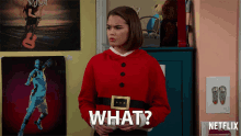 a girl in a red santa suit is asking what