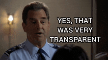 a man in a blue shirt and tie is talking to a woman and says yes that was very transparent
