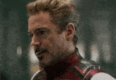 a close up of a man with a beard wearing a superhero costume .