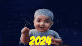 a baby wearing a white hat is pointing at the number 2024