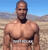 a shirtless man is standing in the desert with the words just relax written on his chest