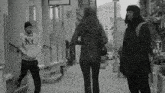 a man wearing a ny hoodie walks down a sidewalk