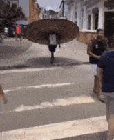 a man is carrying a large plate on his back