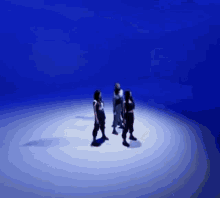 a group of people standing in a circle with a blue background