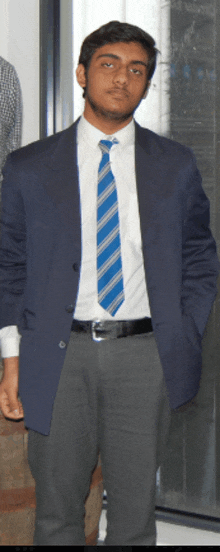 a man wearing a blue jacket and a blue tie
