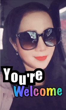 a picture of a woman wearing sunglasses with the words you 're welcome below her