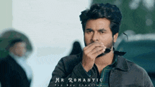 a man covering his mouth with his hand and the words mr romantic written on the bottom