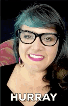 a woman with blue hair and glasses is smiling with hurray written on the bottom