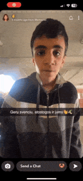 a phone screen shows a picture of a boy and says " send a chat " at the bottom