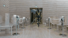 a man in a superhero suit is walking down a hallway