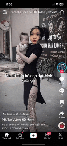 a woman is holding a baby on a cell phone screen