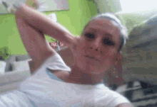 a woman is taking a selfie with her hands behind her head