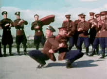 a group of men in military uniforms are dancing on a rooftop