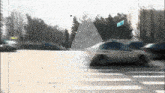 a blurry picture of cars driving down a street with a blue sign that says ' a ' on it