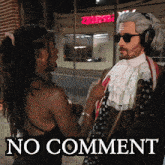 a man in a wig is talking to a woman in front of a no comment sign
