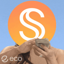 a woman holding a stack of money in front of a large s
