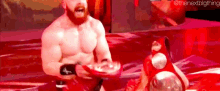 a man with a beard is holding a red object in his hands while standing next to another man .