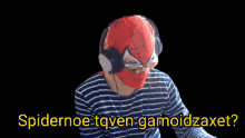 a person wearing a spiderman mask and headphones says spidernoe tqven gamoidzaxt