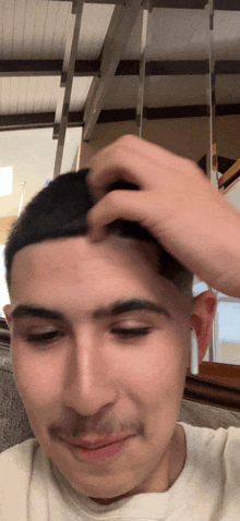a man is scratching his head with his hand