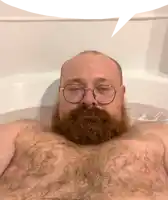a bald man with a beard and glasses is taking a bath