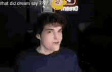 a man is making a funny face in a video with a smiley face .