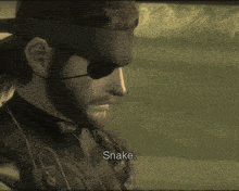 a close up of a man 's face with the word snake below him
