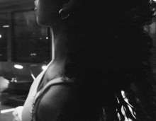 a black and white photo of a woman taking a picture of herself