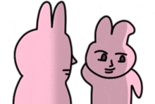 a couple of pink rabbits are standing next to each other .