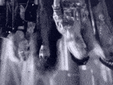 a black and white photo of a group of people walking in a line