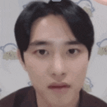 a close up of a person 's face with a blurred background .