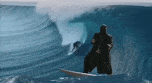 a man riding a wave on a surfboard in the ocean
