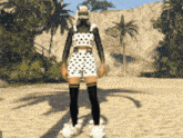 a woman in a polka dot top and shorts is standing on a sandy beach