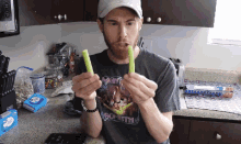 a man wearing a shirt that says mighty boneth is eating celery