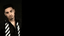 three images of a man wearing a black shirt and white striped tie
