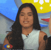 a woman sitting in front of a microphone with a big brother logo in the corner