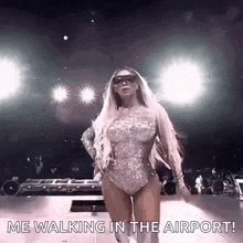 a woman in a bodysuit is walking on a stage with the words `` me walking in the airport '' .
