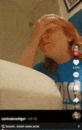 a girl with red hair is covering her face with her hand on a bathroom sink