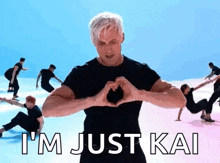 a man is making a heart shape with his hands while dancing .
