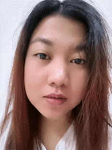 a close up of a woman 's face with a serious look on her face